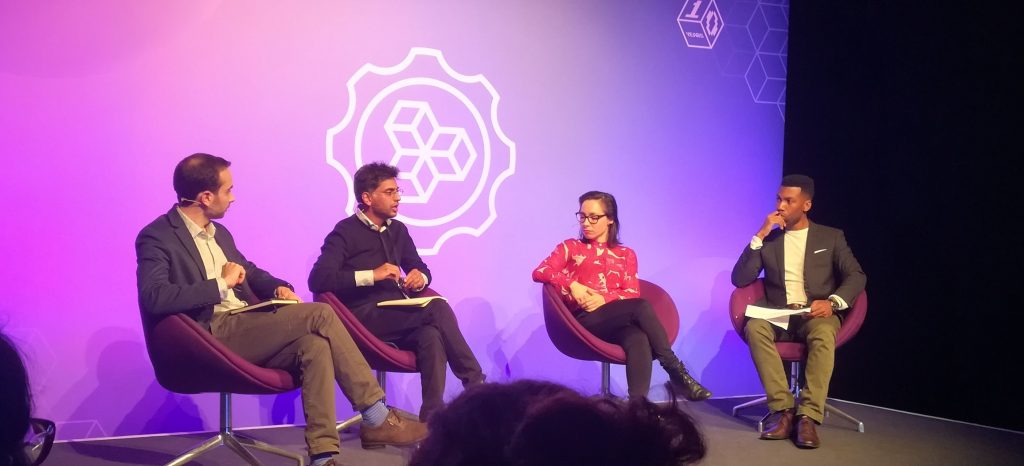 Four people talking on a stage at MozFest