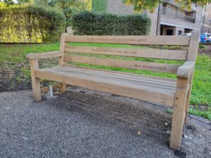 Wooden Kensington bench with Ben Aaronovitch quote.