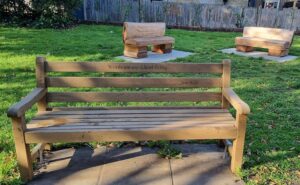 Wooden Kensington bench in Garfield Road Park featuring a quote by author Jess Kidd.