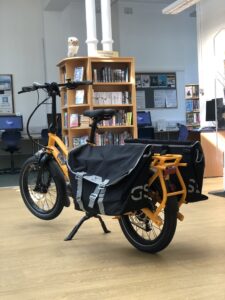 Photograph of the library eBike with two panniers on either side. Located inside the library. 